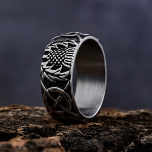 Punk vintage stainless steel cross ring with sunflower engravings on natural bark background