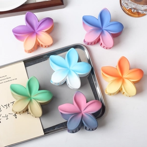 Cute set of six gradient plumeria flower hair claws with matte finish for beach vacations