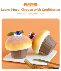 Detailed close-up of artificial cupcakes with realistic blueberries and cherries decoration