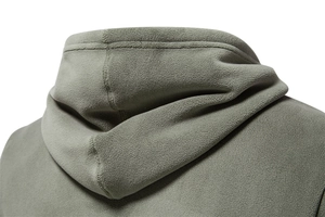 Detail view of polar fleece texture and hoodie hood construction on grey-green sweatshirt