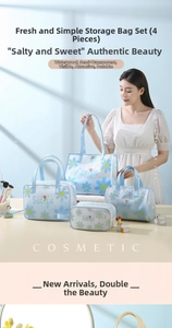 Detail of four-piece waterproof blue daisy cosmetic bag set on a vanity table