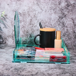 Detail of green translucent acrylic desktop organizer tray with curved backplate
