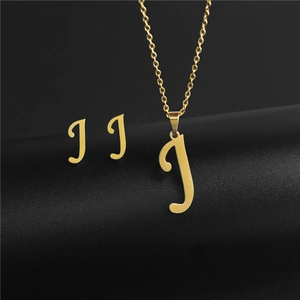 Macro shot of gold stainless steel letter J pendant necklace and stud earrings set