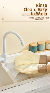 Waterproof silicone oven mitt with anti-slip texture being rinsed under water