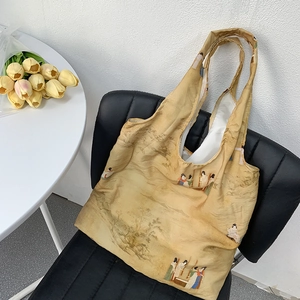 Vintage style mustard yellow canvas tote bag with traditional Chinese art on a black chair