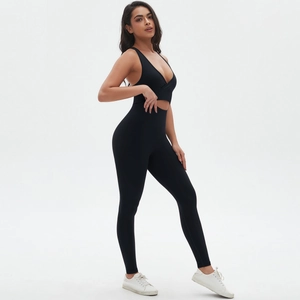 Side view of black seamless criss-cross yoga bodysuit with cutout waist and high stretch