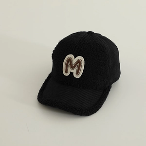 Detailed view of the warm lamb wool texture and M patch on this black kids baseball cap