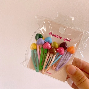 Set of ten colorful heart-shaped resin hair clips in pastel macaron tones with paper card