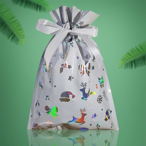 Detail of silver holographic Christmas gift bag with reindeer and snowflake patterns