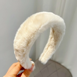 Close-up of beige plush headband texture and soft faux mink fur material detail