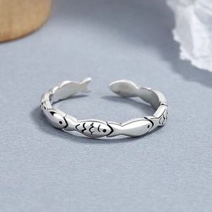 Macro shot of 925 sterling silver adjustable ring with unique vintage fish scale patterns