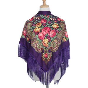 Detail of dark purple Russian style shawl with floral prints and long fringes on mannequin