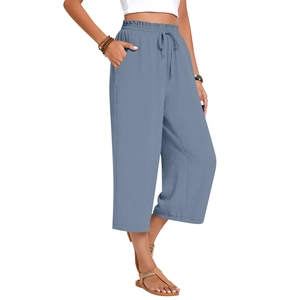 Detail of high waisted blue linen wide leg pants with elastic drawstring waist and pockets