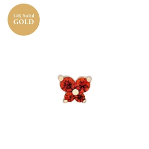 Detail of butterfly earring in 14K solid gold with four red round-cut gemstones