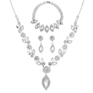 Exquisite bridal crystal jewelry set with silver necklace, earrings and bracelet on white