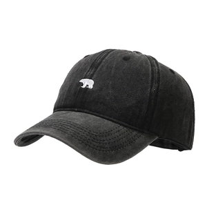 Vintage washed black baseball cap with white polar bear embroidery and curved brim