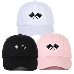 Detailed embroidery of checkered racing flags on white, black, and pink baseball caps