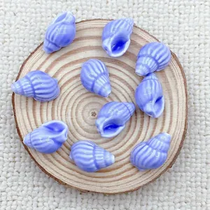 Macro detail of light purple conch shell ceramic beads with stripes for DIY jewelry making