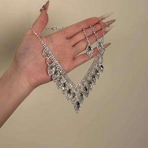 Elegant silver teardrop tassel jewelry set featuring necklace and earrings with rhinestones
