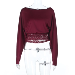 Detail of burgundy lace patchwork on the waist of a long-sleeved cold shoulder top