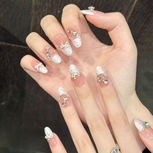 Handmade almond press-on nails with French gradient, 3D bows, and crystal butterfly accents