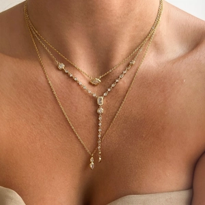 Three-layer gold necklace with oval zircon pendants for a chic minimalist aesthetic