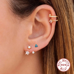 Detailed close-up of S925 sterling silver clover star stud earrings and ear cuffs on model