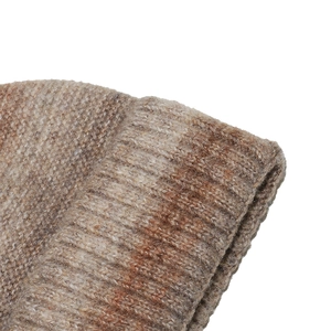 Close-up of brown gradient tie-dye ribbed knit texture on a winter beanie hat