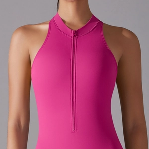 Close-up of pink yoga jumpsuit featuring front zipper and halter sleeveless cut