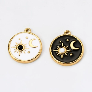 Detail of tarot sun and moon charms with white and black enamel and gold plating