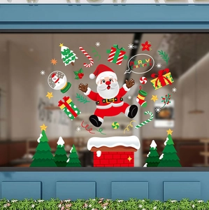 Christmas window decals showing Santa, chimney and tree on a shop glass display