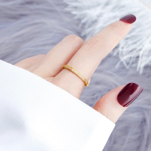Elegant gold titanium ring with micro-paved cubic zirconia shown on model finger