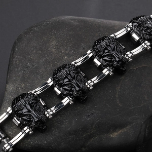 Close-up of lion head stainless steel bracelet with silver and black biker chain detail