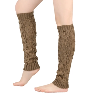 Detailed knit pattern on thick brown leg warmers with hollow leaf design on calves