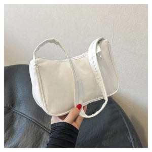 Detail of white PU leather underarm bag with zipper closure and fine leather texture