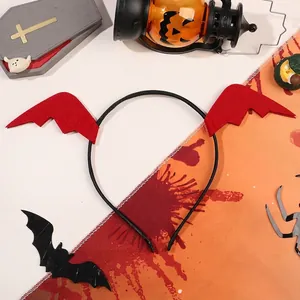 Macro detail of Halloween headband with red devil wings and black base on festive table