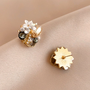 Vintage gold floral stud earrings with white flowers, crystals, and pearls on silk
