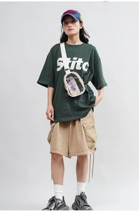 Crossbody jelly bag in transparent PVC with white strap shown on a casual fashion model