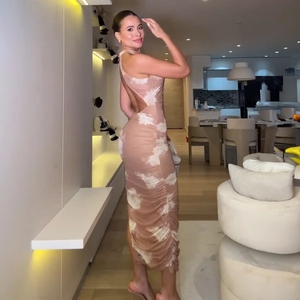 Close-up of ruched side detailing and open back on a patterned summer bodycon dress