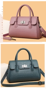 Close-up of embossed crocodile pattern handbag with woven handle and metal twist lock