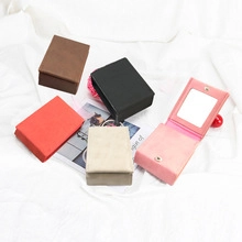 Detail of portable lipstick organizers in multiple colors with built-in makeup mirror