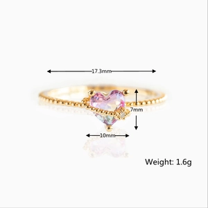 Detail view of a gold ring featuring a purple heart gemstone with size and weight specs