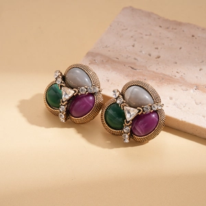Vintage gold earrings with tricolor oval gems and sparkling rhinestones on marble