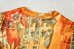 Detail of the invisible back zipper and fine fabric texture on the floral printed dress