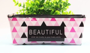 Detail of transparent pencil case with geometric patterns and BEAUTIFUL slogan print
