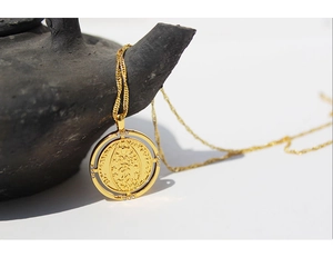 Close-up of gold double-circle coin pendant necklace with micro-set cubic zirconia stones