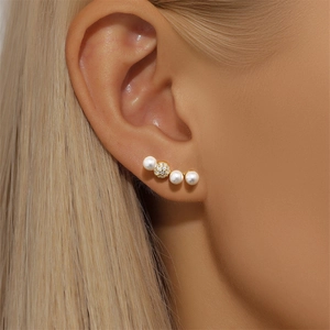 Detailed macro view of S925 sterling silver pearl earrings with sparkling diamond accents
