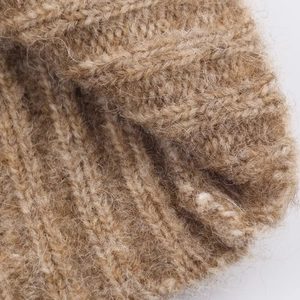 Gros plan d'une robe en tricot camel avec texture douce en laine mohair côtelée
