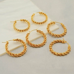 Detail of twisted rope design on gold plated titanium steel hoop earrings with clasp