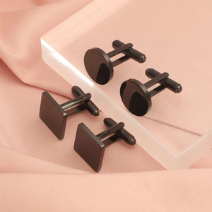 Polished black stainless steel cufflinks in round and square shapes on pink fabric